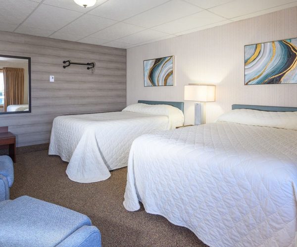 2 beds in 2 bedroom suite and sitting chairs at Welsh’s Motel in Wall, SD 2 beds in 2 bedroom suite and sitting chairs at Welsh's Motel in Wall, SD