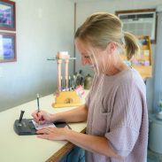 Smiling woman filling out form in the lobby of Welsh’s Motel Smiling woman filling out form in the lobby of Welsh's Motel